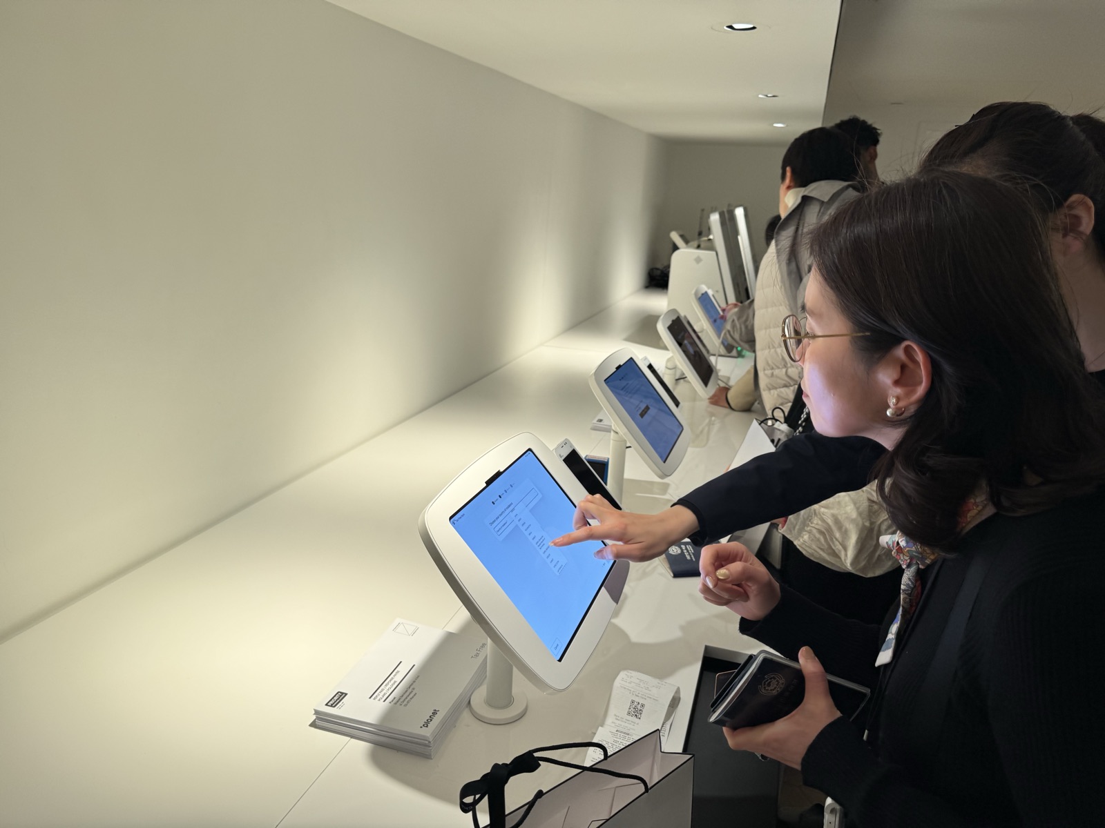 A shopper using a kiosk touchscreen
